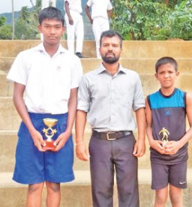 from left - Y. Tharnesh (Putt Shot) in the under 14 category, middle - Coach, Mahesh Sampath Preethiwardena and right - J.Jaganandru (Long Jump) in the under 12 category, was adjudged as the best athletes in their respective categories and fields.    
