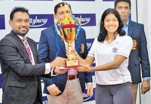 Chanithma Sinale receiving the Ritzbury Junior National Girls’  Squash Champion trophy from Ritzbury Group Manager Aruna Liyanapathirana. Squash Federation President Dhammika Wijesundara and Secretary Eranga Alwis are also in the picture.