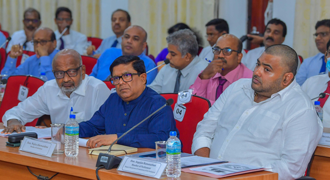 MPs Vajira Abeywardena, Dharmalingam Siddharthan and Angajan Ramanathan with officials at the DDC meeting yesterday.