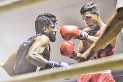 Navy’s AMTS Adhikari (Blue) confronts PSPS Prasanna of Army (Red) in the 67kg Welterweight bout.   
